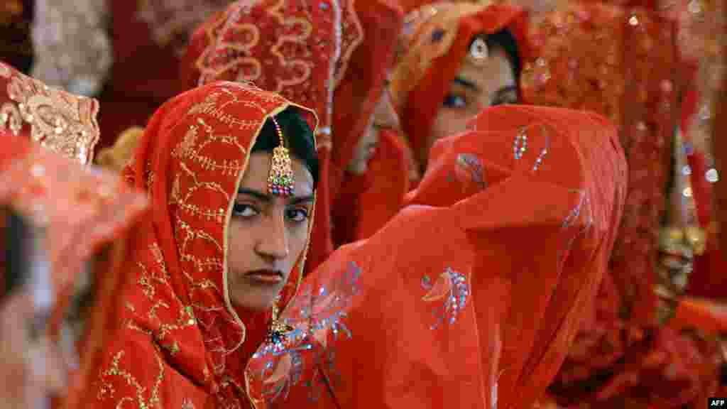 Pakistani brides attend a mass marriage ceremony in Karachi. Some 110 couples participated in the mass wedding ceremony organized by a local charity welfare trust. (AFP/Asif Hassan)