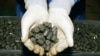 A worker at Kazakhstan's Ulba Metallurgical Works shows nuclear fuel pellets. Kazakhstan has found buyers for its uranium throughout Asia. 