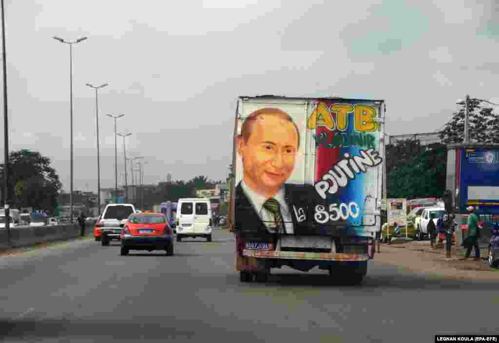 A transport vehicle carries a picture of Russian President Vladimir Putin in Adjame, a district of Abidjan, in Ivory Coast. (epa-EFE/Legnan Koula)