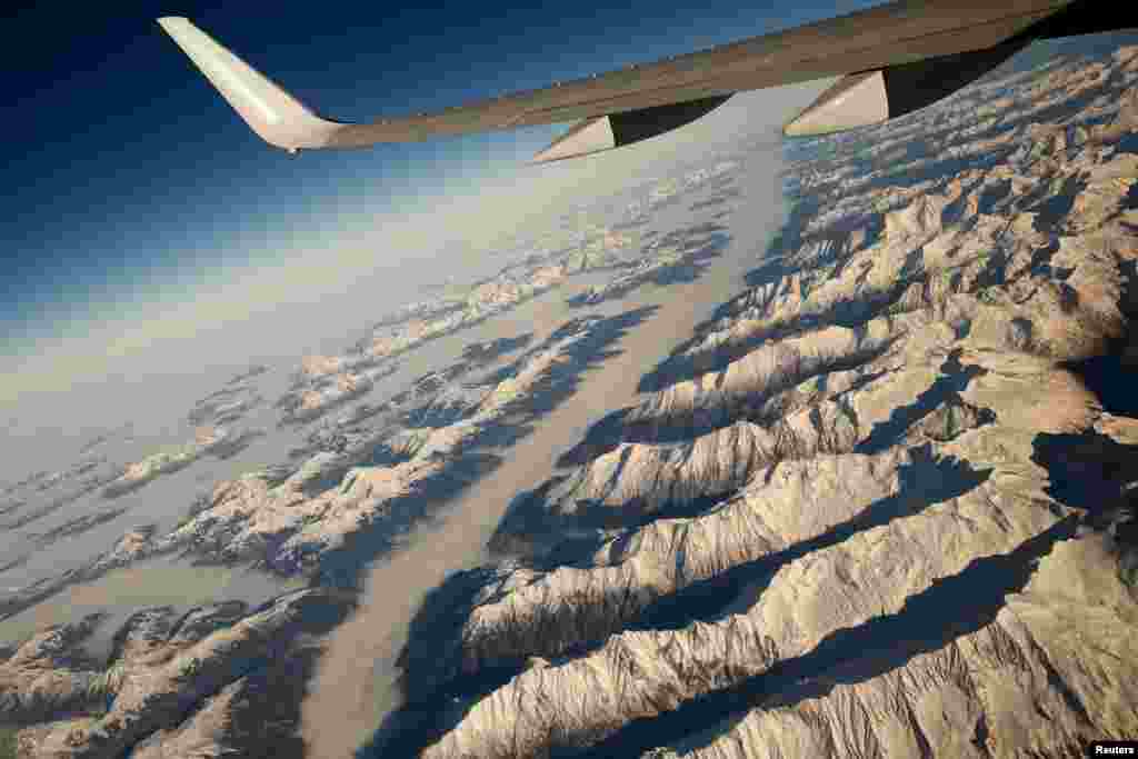 Low-lying clouds cover valleys between peaks in the Austrian Alps as U.S. Secretary of State John Kerry flies over the country to meet with Kosovo's prime minister in Pristina. (Reuters/Jonathan Ernst)