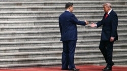 US President Donald Trump (right) shakes hands with Chinese leader Xi Jinping at a welcome ceremony in Beijing on May 14.