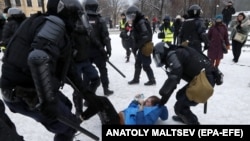 Heavily armored Russian riot police detain a young protester during an unauthorized rally in support of opposition leader Aleksei Navalny in St. Petersburg on January 31. 