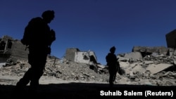 Members of Iraqi federal police patrol in the destroyed Old City of Mosul after IS fighters were driven out.