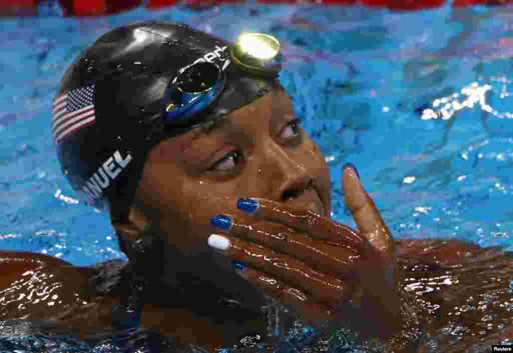 U.S. swimmer Simone Manuel reacts after winning a joint-gold medal in the women&#39;s 100-meter freestyle final in a tie with Canada&#39;s Penny Oleksiak.