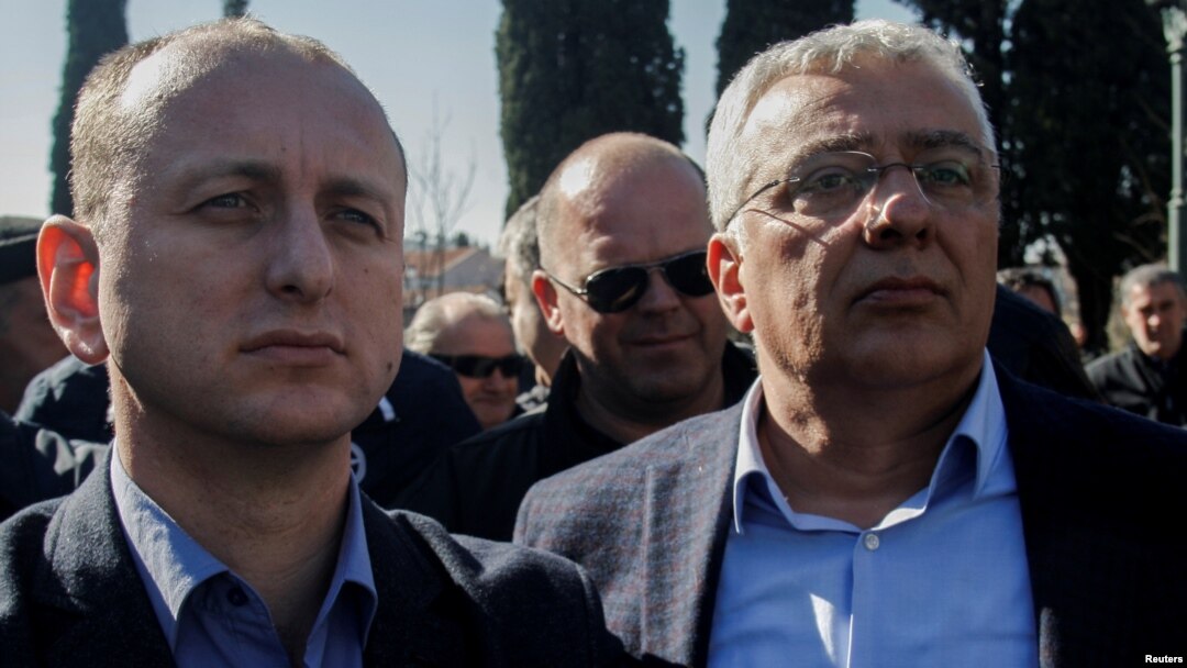 Montenegrin opposition leaders Milan Knezevic (left) and Andrija Mandic wait outside parliament on February 15. 