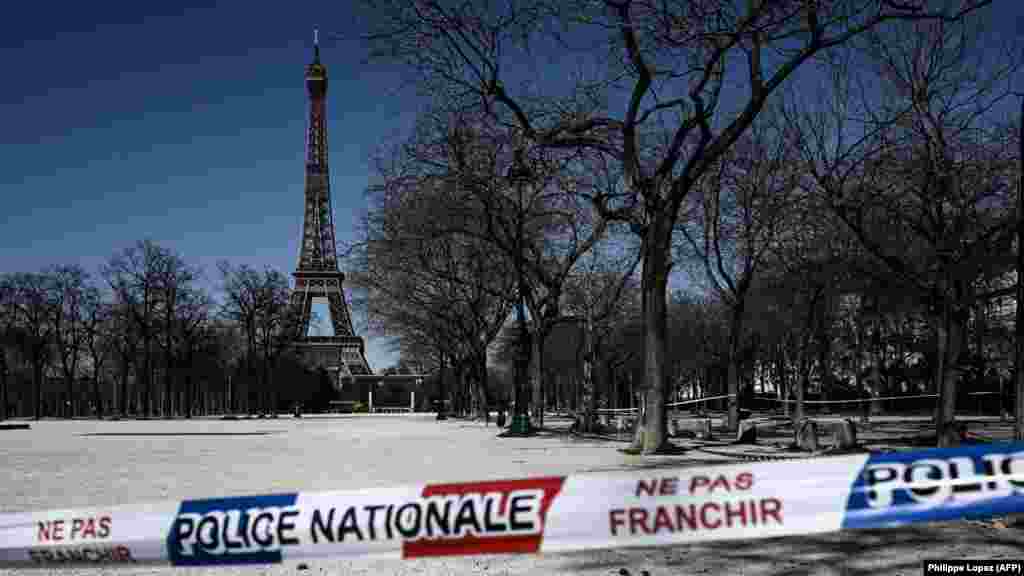 France - A limit set up by the national police is seen at the entrance of a closed park in front of the Eiffel tower in Paris, 23Mar2020