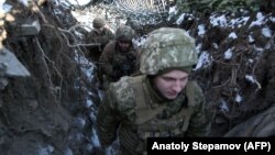 Ukrainian servicemen take up positions on the front line with Russia-backed separatists in the eastern Donetsk region last month.