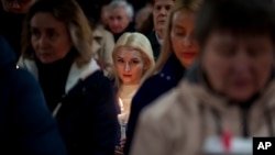 People attend an Easter service at St. Nicholas Roman Catholic Church in Kyiv on March 30.