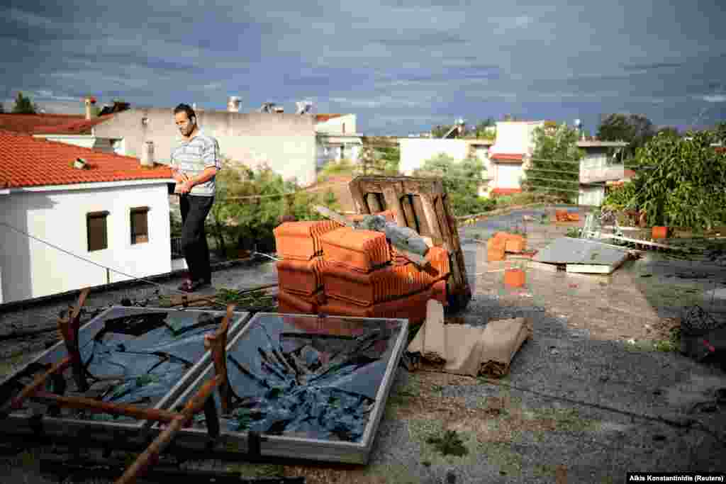 GREECE - A man walks on a damaged terrace following heavy storms at the village of Nea Plagia, Greece, July 11, 2019.