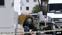 A bomb-disposal expert examines a bag outside the Israeli Embassy in Ankara on September 21.