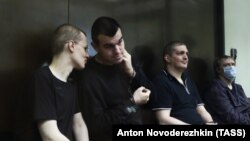 Left to right: Vyacheslav Kryukov, Ruslan Kostylenkov, Pyotr Karamzin and Dmitry Poletayev, members of the New Greatness youth activist group, attend a court hearing in Moscow on July 14. 