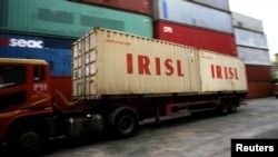 A truck carrying containers from the Islamic Republic of Iran Shipping Lines (IRISL) arrives at a depot in northern Singapore. (file photo)