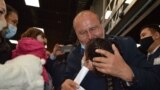 Raqyzhan Zeinolla embraces his granddaughter for the first time at the airport in Almaty on April 9.