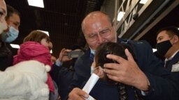 Raqyzhan Zeinolla embraces his granddaughter for the first time at the airport in Almaty on April 9.