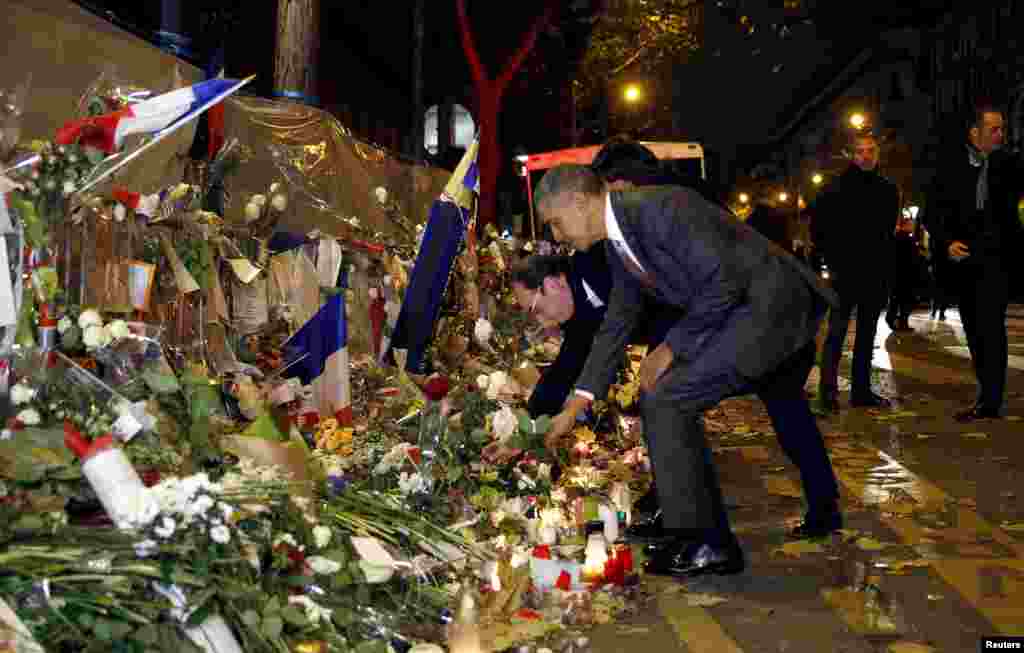 French President Francois Hollande and U.S. President Barack Obama place flowers at a makeshift memorial to pay tribute to the victims of the Paris attacks at the Bataclan in Paris on November 29. (Reuters/Kevin Lamarque)