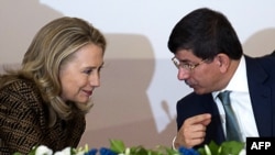 Turkish Foreign Minister Ahmet Davutoglu speaks with U.S. Secretary of State Hillary Clinton in Istanbul earlier this month.