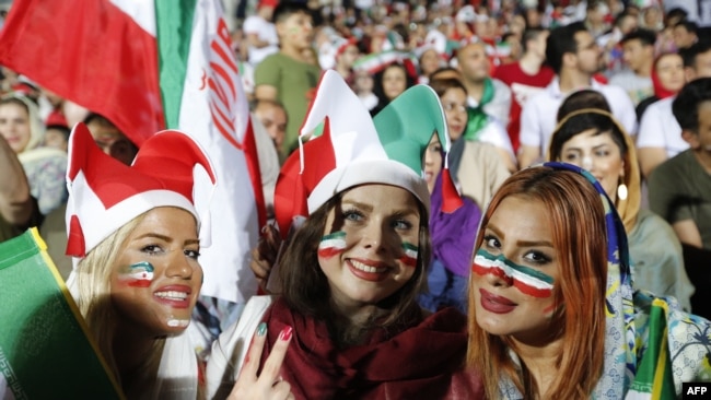 Iranian women watch the World Cup match between Portugal and Iran at Azadi Stadium in Tehran on June 25, 2018.