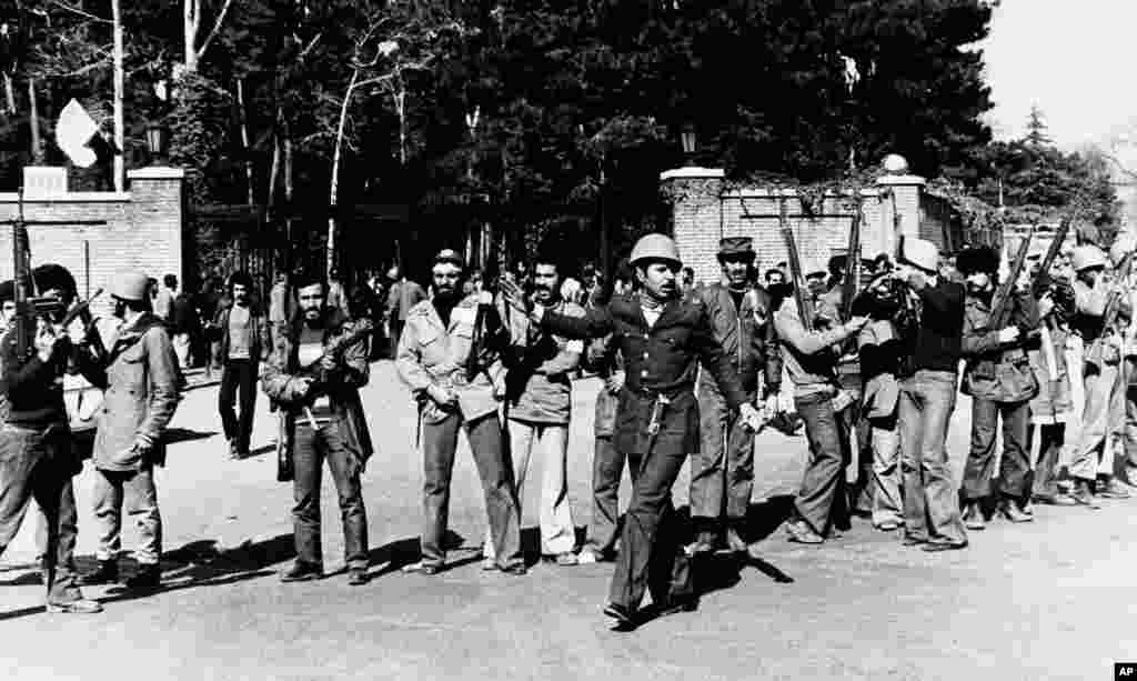 Armed men loyal to the Ayatollah stand in front of the U.S. Embassy in Tehran on February 15, 1979, a day after the compound was stormed.&nbsp; The embassy was briefly held for a few hours before being handed back to the United States. A second attempt to seize the U.S. Embassy would be made in November, leading to a 444-day hostage crisis.