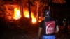 Emergency personnel stand by the burning rubble of a civil defense center following an Israeli air strike in the southern Lebanese city of Nabatieh on May 24.