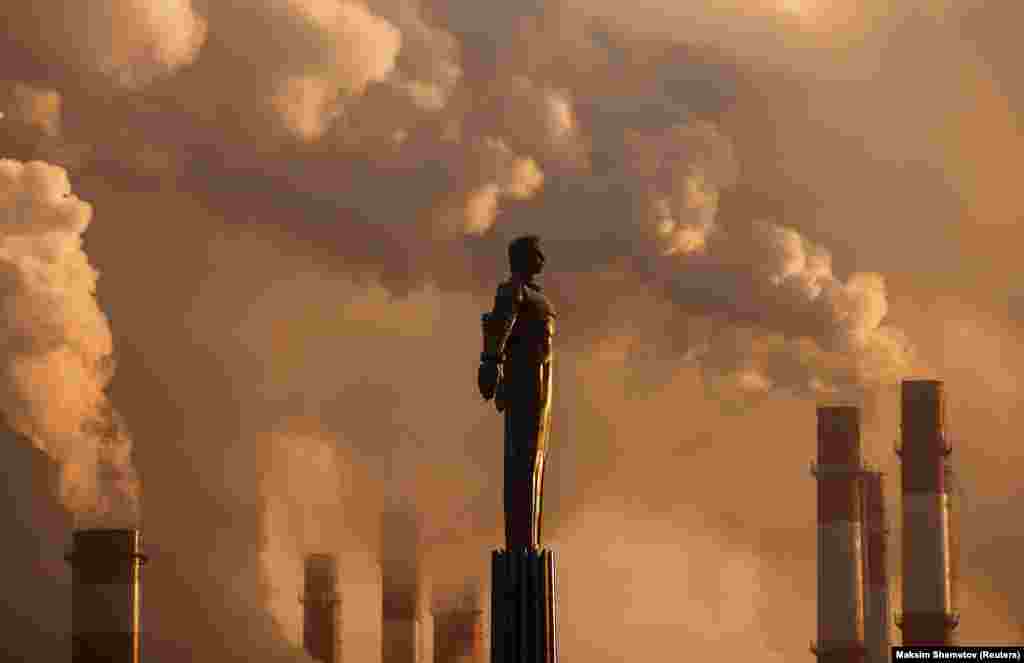 Steam rises from the chimneys of a heating power plant near a monument to Soviet cosmonaut Yury Gagarin during a Moscow sunset. (Reuters/Maksim Shemetov)