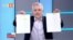 Стоп кадър от предаването "Още от деня" на БНТ от 33 юни 2021 г. Николай Хаджигенов показва документи, които, според него, доказват подслушването на политици.