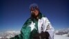Mountaineer Samina Baig poses with a Pakistani flag during a previous climb.