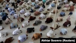 Muslims maintaining distance as they attend Friday Prayers in Karachi on April 24.