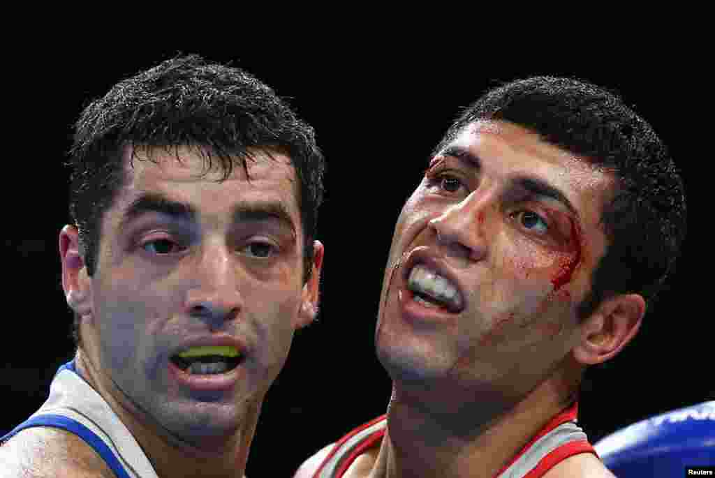 Boxer Shakhobidin Zoirov of Uzbekistan (right) beat two-time Russian world champion Mikhail Aloyan to win gold in the flyweight division.