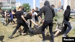 Protesters attack a policeman during the Equality March organized by the LGBT community in Kyiv in June 2015.