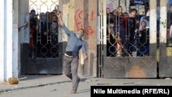 A man hurls an object during clashes between students and Egyptian security forces near Al-Azhar University in Cairo on December 27.