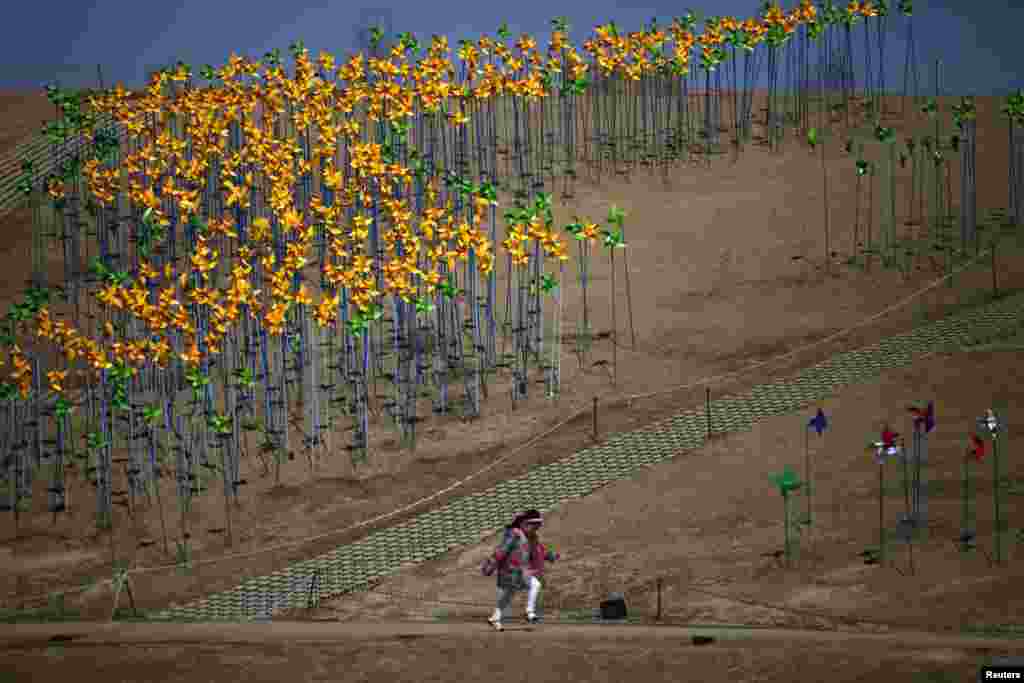 A girl runs past pinwheels arranged in the shape of the Korean peninsula at Imjingak pavillion ini Paju, near the demilitarized zone that separates the two Koreas. (Reuters/Kim Hong-Ji)