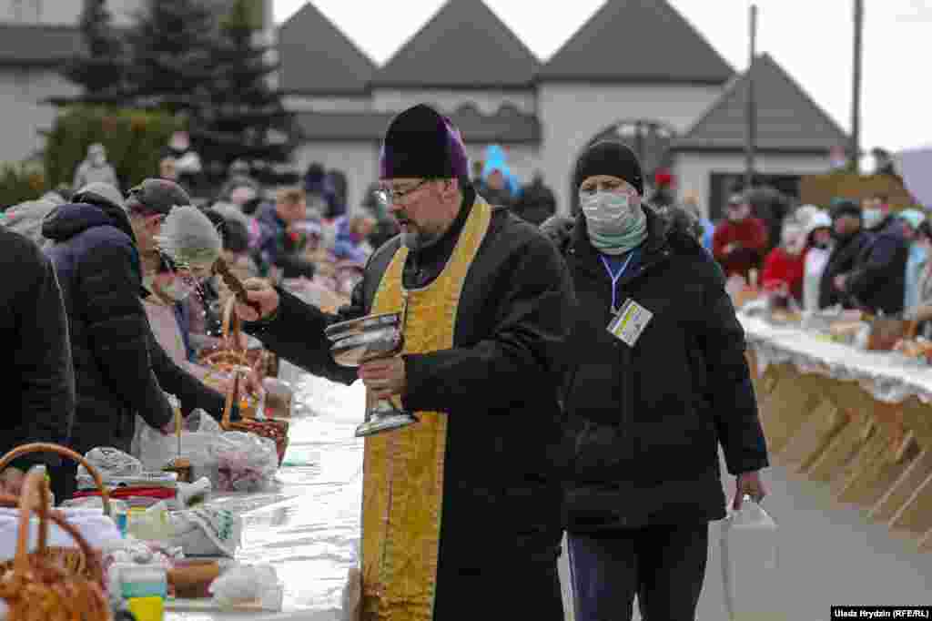 An Orthodox priest blesses believers during Easter celebration in Minsk.