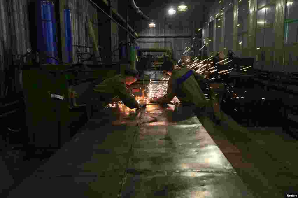 Inmates work in a metal processing shop.