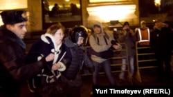 Police detain an activist during a protest rally by the opposition group Another Russia in central Moscow.