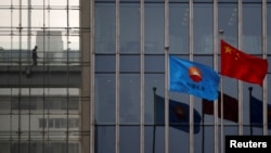 FILE PHOTO: The flag of China National Petroleum Corp (CNPC) flutters next to a Chinese national flag at its headquarters in Beijing March 17, 2015. REUTERS/Kim Kyung-Hoon/File Photo