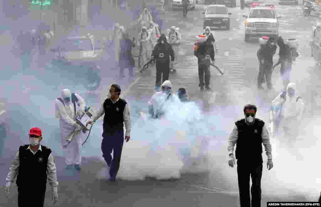 Firefighters disinfect streets in Tehran.