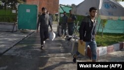 Afghan refugees deported from Germany on a previous repatriation flight arrive at the international airport in Kabul. (file photo)