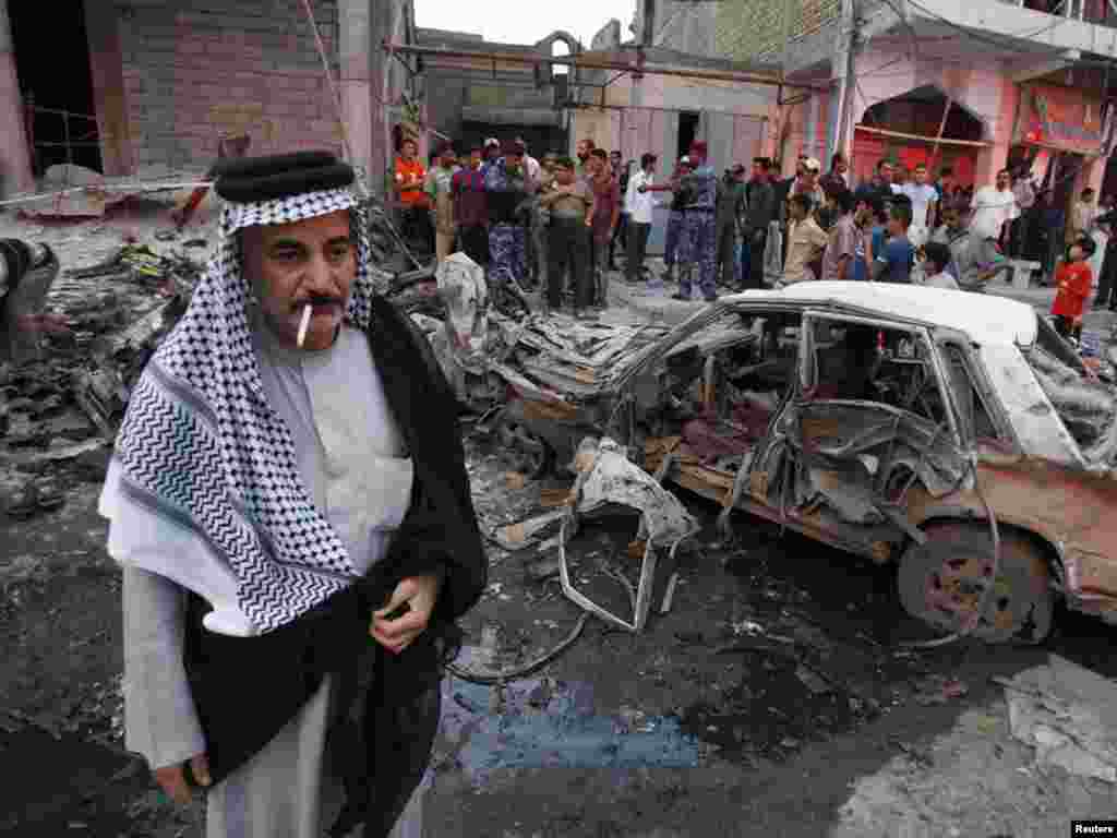 Residents gather at the site of a bomb attack in Basra, southern Iraq. - Photo by Atef Hassan for Reuters