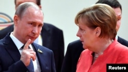 German Chancellor Angela Merkel (right) talks to Russian President Vladimir Putin at the start of the first working session of the G20 meeting in Hamburg in July 2017.