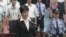 A TV grab shows Gu Kailai, wife of ousted Chinese Communist Party Politburo member Bo Xilai, standing in court in Hefei.