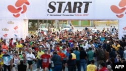 File - Participants attend the first international Tehran marathon at Azadi Square in Tehran, April 7, 2017