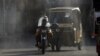 Workers spray disinfectant along a street as a preventive measure against the spread of the coronavirus in Karachi. 