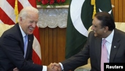 U.S. Vice President Joe Biden (left) shares a laugh while sitting down to meet with Pakistan's President Asif Ali Zardari in Islamabad