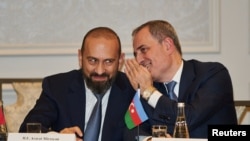 Azerbaijani Foreign Minister Jeyhun Bayramov whispers in the ear of his Armenian counterpart, Ararat Mirzoyan, during a meeting about the Trump Route for International Peace and Prosperity in New York on September 23, 2026.