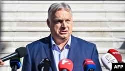 Hungarian Prime Minister Viktor Orban addresses journalists in front of a polling station in Budapest on June 9.