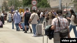 People leaving Iran via the Agarak border crossing with neighboring Armenia.