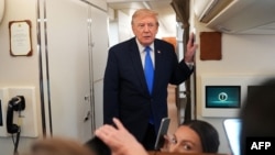 US President Donald Trump speaks to reporters aboard Air Force One on August 2.