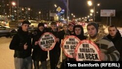 A group of Stopkham activists stand by a highway in northern Moscow where they stop drivers who illegally use the hard shoulder.