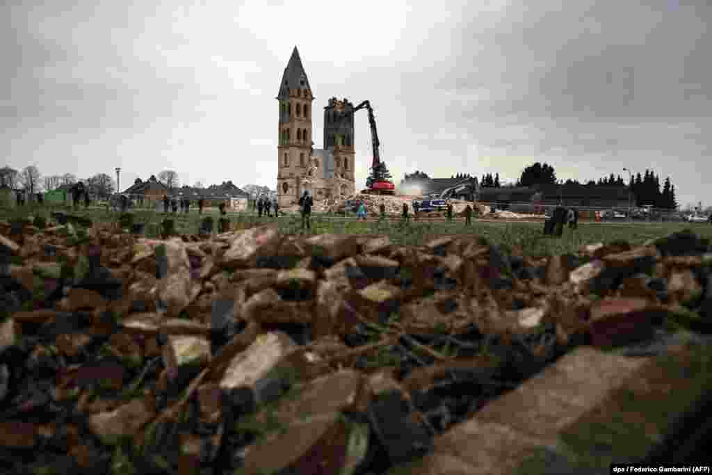 The St. Lambertus church in Erkelenz-Immerath, in western Germany, is demolished in order to make way for the mining of brown coal. Residents of the village of Immerath were previously relocated, as the area is to be exploited by German energy supplier RWE Power in an extension of their Tagebau Garzweiler open-pit lignite mine. (AFP/Federico Gambarini)