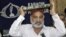 Zulfiqar Mirza, a senior minister in the southern Sindh Province, holds the Koran aloft as he announces his resignation from the government